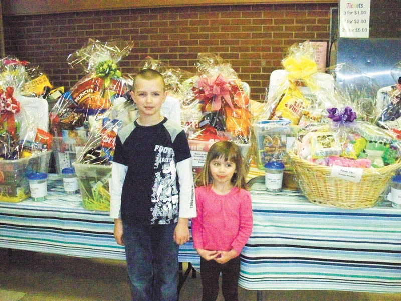 SPECIAL TO THE VINDICATOR
Austintown Community Church Preschool Childcare Center will host its annual Trash and Treasure Sale from 9 a.m. to 1 p.m. March 22 in the youth auditorium of the education wing of Austintown Community Church, 242 S. Canfield-Niles Road. Preschool childcare students Evan and Victoria Jones, above, are showing off some of the specialty raffle baskets that will be available at the sale. Drawings will take place at 12:45 p.m., and winners do not need to be present. Snacks, light lunch items and beverages will be available for purchase. Tables or information are available by calling the preschool office at 330-793-1843 from 9 a.m. to 4 p.m. Monday through Friday or visit www.yourACC.org.