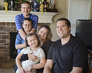 The Terlesky family poses for a photo in their Boardman home Thursday, March 6, 2014...L-R.Brian Jr. 14, Tyler 9, Emma 5, Christie, and Briand Sr.
