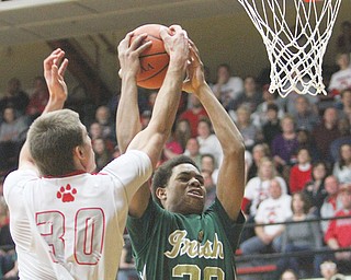 Ursuline’s Dave Collins goes to the hoop past Trent Davis of Norwayne during the first half of their Division III regional semifinal Thursday at the Canton Fieldhouse. The Irish dominated the Bobcats, 74-56.