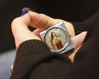  .          ROBERT  K. YOSAY | THE VINDICATOR..every little bit helps as a parent holds St Theresa ...-30-