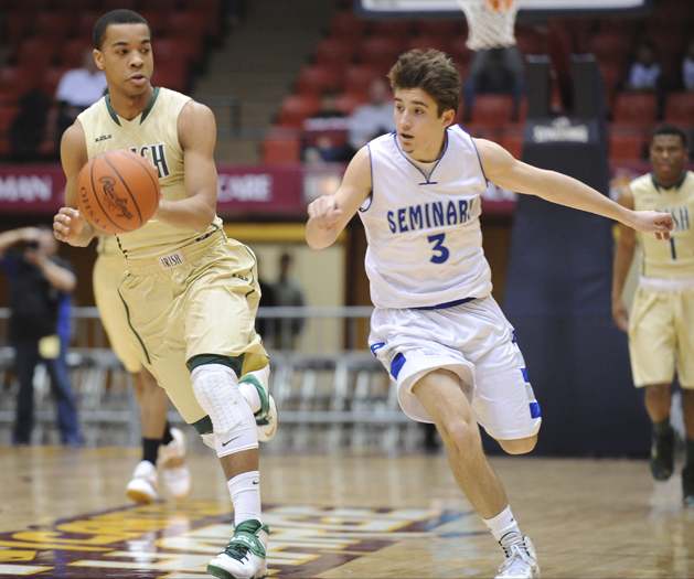 CANTON, OHIO - MARCH 15, 2014: Josh Williams of SVSM dribbles the ball up court out of the reach of Nick Gajdos #3 of Poland during the first half of the regional final game Saturday afternoon at the Canton Civic Center.