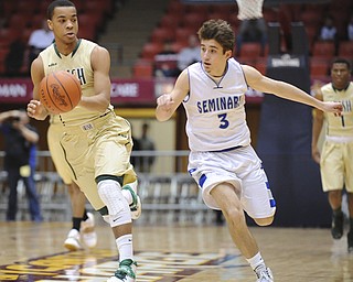 CANTON, OHIO - MARCH 15, 2014: Josh Williams of SVSM dribbles the ball up court out of the reach of Nick Gajdos #3 of Poland during the first half of the regional final game Saturday afternoon at the Canton Civic Center.