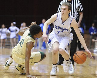 CANTON, OHIO - MARCH 15, 2014: Jared Burkert #23 of Poland looks to pass the ball after tripping up Johnnie Robinson #2 of SVSM during the first half of the regional final game Saturday afternoon at the Canton Civic Center.