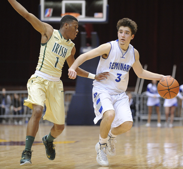 CANTON, OHIO - MARCH 15, 2014: Nick Gajdos #3 of Poland dibbles the ball up court while being pressured by Jarel Woolridge #1 of SVSM during the first half of the regional final game Saturday afternoon at the Canton Civic Center.