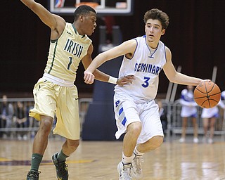 CANTON, OHIO - MARCH 15, 2014: Nick Gajdos #3 of Poland dibbles the ball up court while being pressured by Jarel Woolridge #1 of SVSM during the first half of the regional final game Saturday afternoon at the Canton Civic Center.