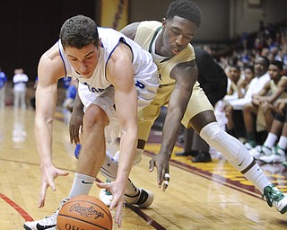CANTON, OHIO - MARCH 15, 2014: Jacob Wolfe #5 of Poland and Parris Campbell Jr. of SVSM reach for a loose ball after it was misplayed by Wolfe during the first half of the regional final game Saturday afternoon at the Canton Civic Center.