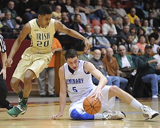 CANTON, OHIO - MARCH 15, 2014: Jacob Wolfe #5 of Poland attempts to gain control of the basketball on the dribble after taking it away from Henry Bradley #20 of SVSM and losing his footing during the second half of the regional final game Saturday afternoon at the Canton Civic Center.