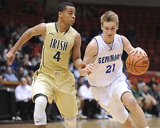 CANTON, OHIO - MARCH 15, 2014: Kyle Dixon #21 of Poland dribbles to the basket while Jayvon Graves guards him during the second half of the regional final game Saturday afternoon at the Canton Civic Center.