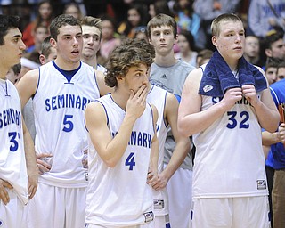 CANTON, OHIO - MARCH 15, 2014: Jacob Wolfe #5, Steven Andrews #4, and # Danny Black #32 of Poland react while watching players for SVSM celebrate on the court after the regional final game Saturday afternoon at the Canton Civic Center. Poland #33 George Chammas pictured.
