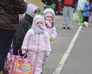 Katie Rickman  | The Vindicator.Leah Zolla, 2, and her sister Kate, 4, of Canfield watch as the St. Patrick's Day Parade passes by in Boardman.
