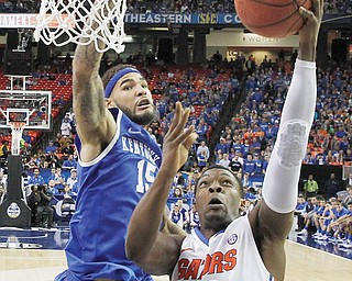 Florida guard Michael Frazier II (20) shoots against Kentucky forward Willie Cauley-Stein (15) during the second
half of the Southeastern Conference men’s championship Sunday. Florida won 61-60 and earned the No. 1
seed in the NCAA tournament.