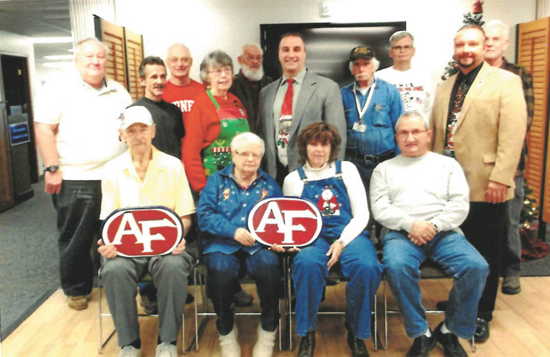 SPECIAL TO THE VINDICATOR
One of the many classes offered at the Austintown Senior Center is woodcarving. Beginning in the fall, the class spent hours carving two plaques of the Austintown School logo. At the December meeting, they presented Vince Colaluca, schools superintendant, with the plaques. Class members are, seated from left, Marty Trebus, Dorothy Cover, Patty McSuley and Roy Sauline. In the middle are Tom Evans, Darryl Gassler, Diane Ziegler, Colaluca, Ron Walker and Mark Cole, Austintown Rotary president. In the back row are Bob Ziegler, Keith Kingaman, Garry Sullivan and Chuck Mound. Other members are Carol Beadnell, Bob Stas, Don Mortimer and Jessica Ricker.