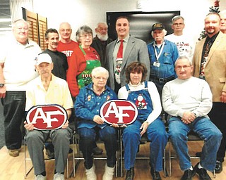 SPECIAL TO THE VINDICATOR
One of the many classes offered at the Austintown Senior Center is woodcarving. Beginning in the fall, the class spent hours carving two plaques of the Austintown School logo. At the December meeting, they presented Vince Colaluca, schools superintendant, with the plaques. Class members are, seated from left, Marty Trebus, Dorothy Cover, Patty McSuley and Roy Sauline. In the middle are Tom Evans, Darryl Gassler, Diane Ziegler, Colaluca, Ron Walker and Mark Cole, Austintown Rotary president. In the back row are Bob Ziegler, Keith Kingaman, Garry Sullivan and Chuck Mound. Other members are Carol Beadnell, Bob Stas, Don Mortimer and Jessica Ricker.