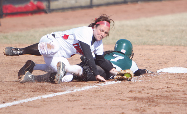 Youngstown State’s Samantha Snodgrass rolls over Eastern Michigan’s Abby Davidson during Game One of the Penguins’ season-opening doubleheader Tuesday at the new YSU Softball Complex. The Penguins shut out the Eagles, 7-0, but fell in the nightcap, 6-3.
