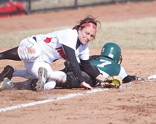 Youngstown State’s Samantha Snodgrass rolls over Eastern Michigan’s Abby Davidson during Game One of the Penguins’ season-opening doubleheader Tuesday at the new YSU Softball Complex. The Penguins shut out the Eagles, 7-0, but fell in the nightcap, 6-3.