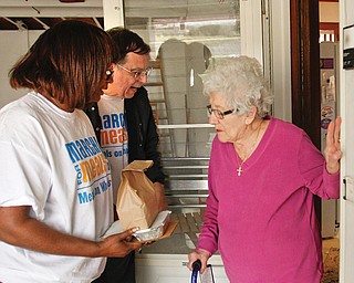 Jennie Columbo, a West Side resident who recently began receiving Meals on Wheels, greets Janet Tarpley, 6th Ward councilwoman in Youngstown, and Jim Carmany of New Middletown, a volunteer driver. On Wednesday, the Meals on Wheels March for Meals Campaign involved public officials who helped deliver to clients. Columbo said she likes the service.