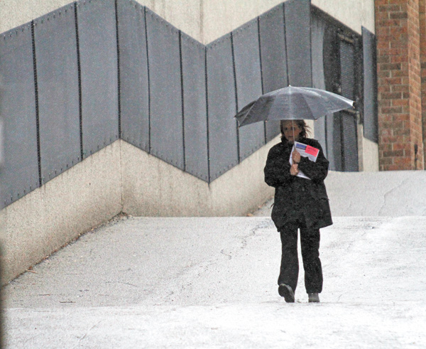 Today is the first day of spring, but temperatures aren’t expected to improve until the beginning of next month. This is the third-coldest start to a year in the Mahoning Valley. Above, Gina McGranahan of New Castle,
Pa., walks in the rain Wednesday on the campus of Youngstown State University, where she works.