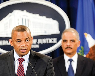 Transportation Secretary Anthony Foxx. left, accompanied by Attorney General Eric Holder, talks about a $1.2 billion settlement with Toyota over its disclosure of safety problems Wednesday during a news conference at the Justice Department in Washington.