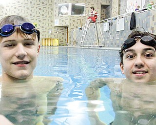 Y-Neptunes teammates Jordan Stackpole, left, and Noah Basista practice in the pool at the Youngstown YMCA. The boys will be competing this weekend in Columbus at the Great Lakes Zone Championships at Ohio State
University.