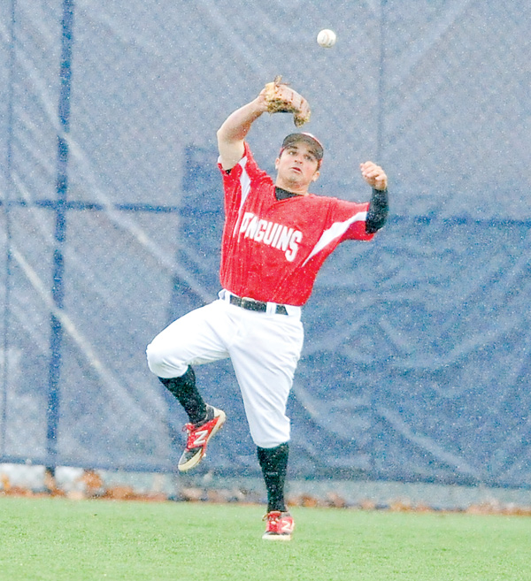 Youngstown State center fielder Mike Accardi can’t hang on to a fly ball in the rain during Wednesday’s game against Kent State at Schoonover Stadium in Kent. The Penguins fell to the Golden Flashes, 10-2, in six innings.