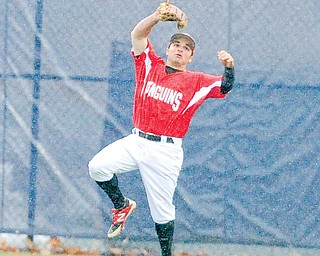 Youngstown State center fielder Mike Accardi can’t hang on to a fly ball in the rain during Wednesday’s game against Kent State at Schoonover Stadium in Kent. The Penguins fell to the Golden Flashes, 10-2, in six innings.
