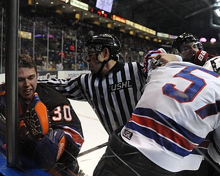YOUNGSTOWN, OHIO - MARCH 21, 2014: Goalie Sean Romeo #30 is separated from Dennis Yan #57 of Team USA during a brawl during the 1st period of Friday morning against Team USA at the Covelli Centre. The Phantoms won 7-3.