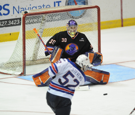 YOUNGSTOWN, OHIO - MARCH 21, 2014: Goalie Sean Romeo #30 of the Phantoms tracks down the puck after a shot from Brody Stevens #52 of Team USA during the 2nd period of Friday morning against Team USA at the Covelli Centre. The Phantoms won 7-3.