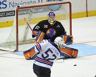 YOUNGSTOWN, OHIO - MARCH 21, 2014: Goalie Sean Romeo #30 of the Phantoms tracks down the puck after a shot from Brody Stevens #52 of Team USA during the 2nd period of Friday morning against Team USA at the Covelli Centre. The Phantoms won 7-3.