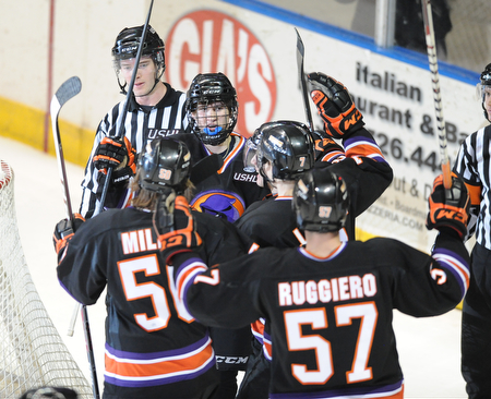 YOUNGSTOWN, OHIO - MARCH 21, 2014: Trey Bradley #10 of the Phantoms is congratulated by his teammates #50 Matt Miller, #57 Steven Ruggiero, #7 Maxim Letunov, and #8 Josh Melnick after scoring the 5th goal of the game during the 2nd period of Friday morning against Team USA at the Covelli Centre. The Phantoms won 7-3.