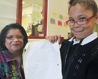 Taniya Phillips, right, holds her first-place essay with Delphine Baldwin-Casey, commander of the Youth Police Academy. Taniya, a third-grader at Martin Luther King Elementary School, wrote the essay, “Why I Never Want to Go to Jail,” after a visit by the Youngstown City Schools Afterschool Alliance and the Youth Police Academy last month to the Martin P. Joyce Juvenile Justice Center in Youngstown.