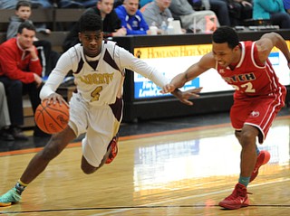 HOWLAND, OHIO - MARCH 25, 2014: Asim Pleas #4 of Liberty dribbles to the basket inside of Quincy Higgins #22 of Fitch during Tuesday nights Frank Bubba Classic boys basketball all-star game at Howland High School.