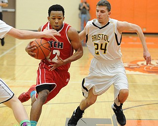 HOWLAND, OHIO - MARCH 25, 2014: Quincy Higgins #22 of Fitch dribbles to the basket inside of Brandon Lee of Bristol during Tuesday nights Frank Bubba Classic boys basketball all-star game at Howland High School.