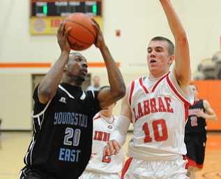 HOWLAND, OHIO - MARCH 25, 2014: Terrell McClain #20 of East attempts to put up a shot while Peyton Aldridge #10 of Labrae goes for the block during Tuesday nights Frank Bubba Classic boys basketball all-star game at Howland High School.