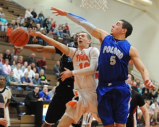 HOWLAND, OHIO - MARCH 25, 2014: Ozzie Hawkins #10 of Newton Falls has the ball blocked by Jake Wolfe #5 of Poland and Terrell McClain #20 of East during Tuesday nights Frank Bubba Classic boys basketball all-star game at Howland High School.