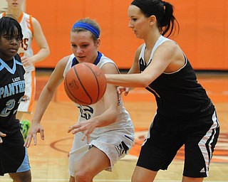 HOWLAND, OHIO - MARCH 25, 2014: Ashleigh Ryan #1 of Struthers slaps the ball away from Alli Pavlik #15 of Lakeview during the second half of Tuesday night's Frank Bubba Classic girls basketball all-star game at Howland High School. Mahoning County won 67-62.