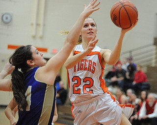 HOWLAND, OHIO - MARCH 25, 2014: Gabby Cvengros #22 of Howland goes to the basket while being pressured by Kelsie Settle #14 of Sebring during the second half of Tuesday nights Frank Bubba Classic girls basketball all-star game at Howland High School. Mahoning County won 67-62.