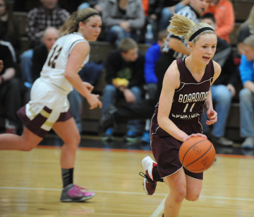 HOWLAND, OHIO - MARCH 25, 2014: Megan Volosin #11 of Boardman dribbles up court away from Leah Leshnack #12 of Liberty during the second half of Tuesday nights Frank Bubba Classic girls basketball all-star game at Howland High School. Mahoning County won  67-62.