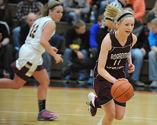 HOWLAND, OHIO - MARCH 25, 2014: Megan Volosin #11 of Boardman dribbles up court away from Leah Leshnack #12 of Liberty during the second half of Tuesday nights Frank Bubba Classic girls basketball all-star game at Howland High School. Mahoning County won 67-62.