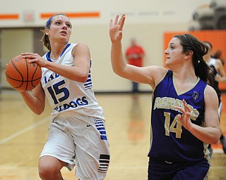 HOWLAND, OHIO - MARCH 25, 2014: Alli Pavlik #15 of Lakeview looks to the basket while being guarded by Kelsie Settle #14 of Sebring during the second half of Tuesday nights Frank Bubba Classic girls basketball all-star game at Howland High School. Mahoning County won 67-62.