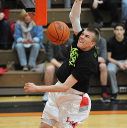 HOWLAND, OHIO - MARCH 25, 2014: Peyton Aldridge #10 of Labrae slams the ball home during the boys slam dunk contest before of Tuesday nights Frank Bubba Classic boys basketball all-star game at Howland High School.