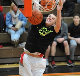 HOWLAND, OHIO - MARCH 25, 2014: Peyton Aldridge #10 of Labrae slams the two balls home during the boys slam dunk contest before of Tuesday nights Frank Bubba Classic boys basketball all-star game at Howland High School.
