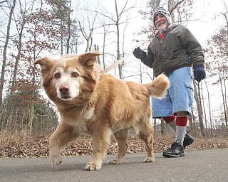 Jerry Schromofsky and his dog, Missy, walk in Mill Creek Park on Tuesday. Schromofsky, who lives in Youngstown, said he walks for exercise several days a week and also regularly works out at a gym.