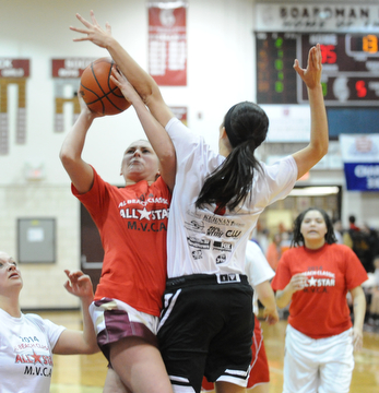 David W. Dermer | The Vindicator
BOARDMAN, OHIO - MARCH 26, 2014: Leah Leshnack of Liberty goes to the basket while avoiding the block from Ashleigh Ryan of Struthers during the 2014 Al Beach All Star game Wednesday night at Boardman High School.