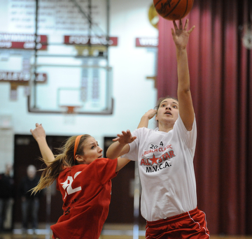 David W. Dermer | The Vindicator
BOARDMAN, OHIO - MARCH 26, 2014: Megan Sefcik of Fitch puts up a shot over Gabby Cvengros of Howland  during the 2014 Al Beach All Star game Wednesday night at Boardman High School...