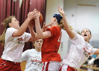 David W. Dermer | The Vindicator
BOARDMAN, OHIO - MARCH 26, 2014: Cassie Custer #15 from Fitch and Sarah Cash #20 from Lordstown and Aleah Whitacre #12 of Columbiana battle for a rebound after a missed shot during the 2014 Al Beach All Star game Wednesday night at Boardman High School. ..