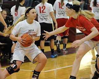 David W. Dermer | The Vindicator.BOARDMAN, OHIO - MARCH 26, 2014: Jenna Kuczek #33 of Boardman looks to pass the ball while Sarah Cash #20 of Loardstown plays defense during the 2014 Al Beach All Star game Wednesday night at Boardman High School. ..