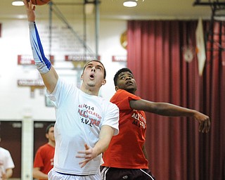 David W. Dermer | The Vindicator
BOARDMAN, OHIO - MARCH 26, 2014: Jacob Wolfe #5 of Poland puts up a shot after avoiding the swipe from Asim Pleas #4 from Liberty during the 2014 Al Beach All Star game Wednesday night at Boardman High School. ..