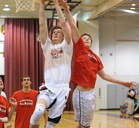David W. Dermer | The Vindicator.BOARDMAN, OHIO - MARCH 26, 2014: Andrew Midgley #11 of Canfield attempts to dunk over Zac Hagy #6 of Mineral Ridge during the 2014 Al Beach All Star game Wednesday night at Boardman High School.