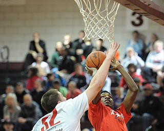 David W. Dermer | The Vindicator
BOARDMAN, OHIO - MARCH 26, 2014: Jamar Tarver #20 of Brookfield goes to the basket avoiding the block from Max Wolfgang #32 of Salem during the 2014 Al Beach All Star game Wednesday night at Boardman High School. ..