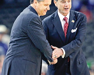 Louisville head coach Rick Pitino, right, shakes hands with Kentucky head coach John Calipari before a 2012 Final Four game in New Orleans. The two teams face off again this year in the Sweet 16, and the Wildcats would love to dash the Cardinals’ dreams of a third straight Final Four appearance.